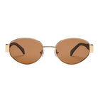 Oval gold-framed sunglasses with brown tinted lenses and black temple tips on white background