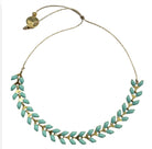 Brass chain necklace with turquoise leaf-shaped beads arranged in a delicate botanical pattern with adjustable clasp