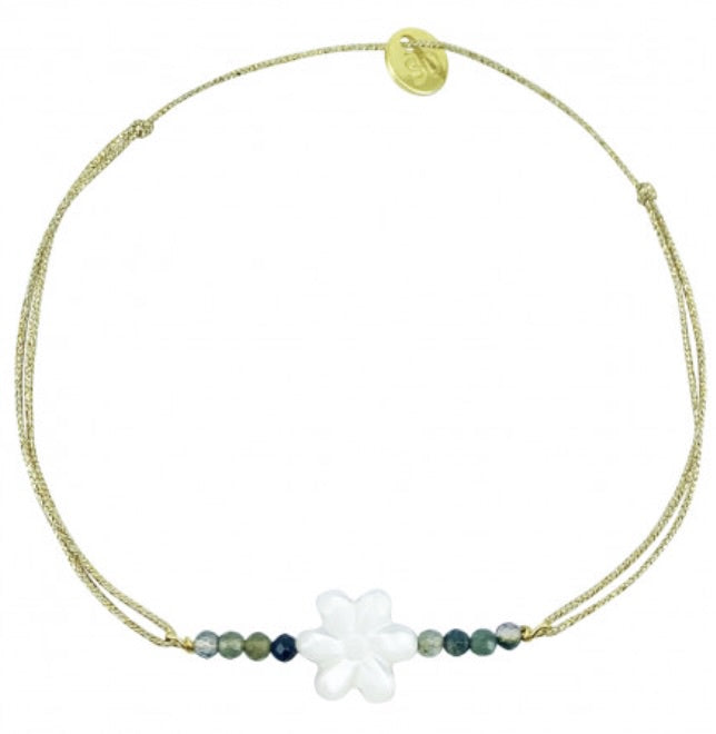 Delicate gold cord bracelet with white flower charm and teal beaded accents, adjustable sliding closure
