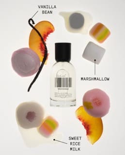 White perfume bottle surrounded by colorful marshmallow candies and vanilla bean with ingredient labels on white background