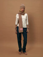 Striped knit beanie and scarf set in tan, brown, and black horizontal stripes with matching fingerless gloves