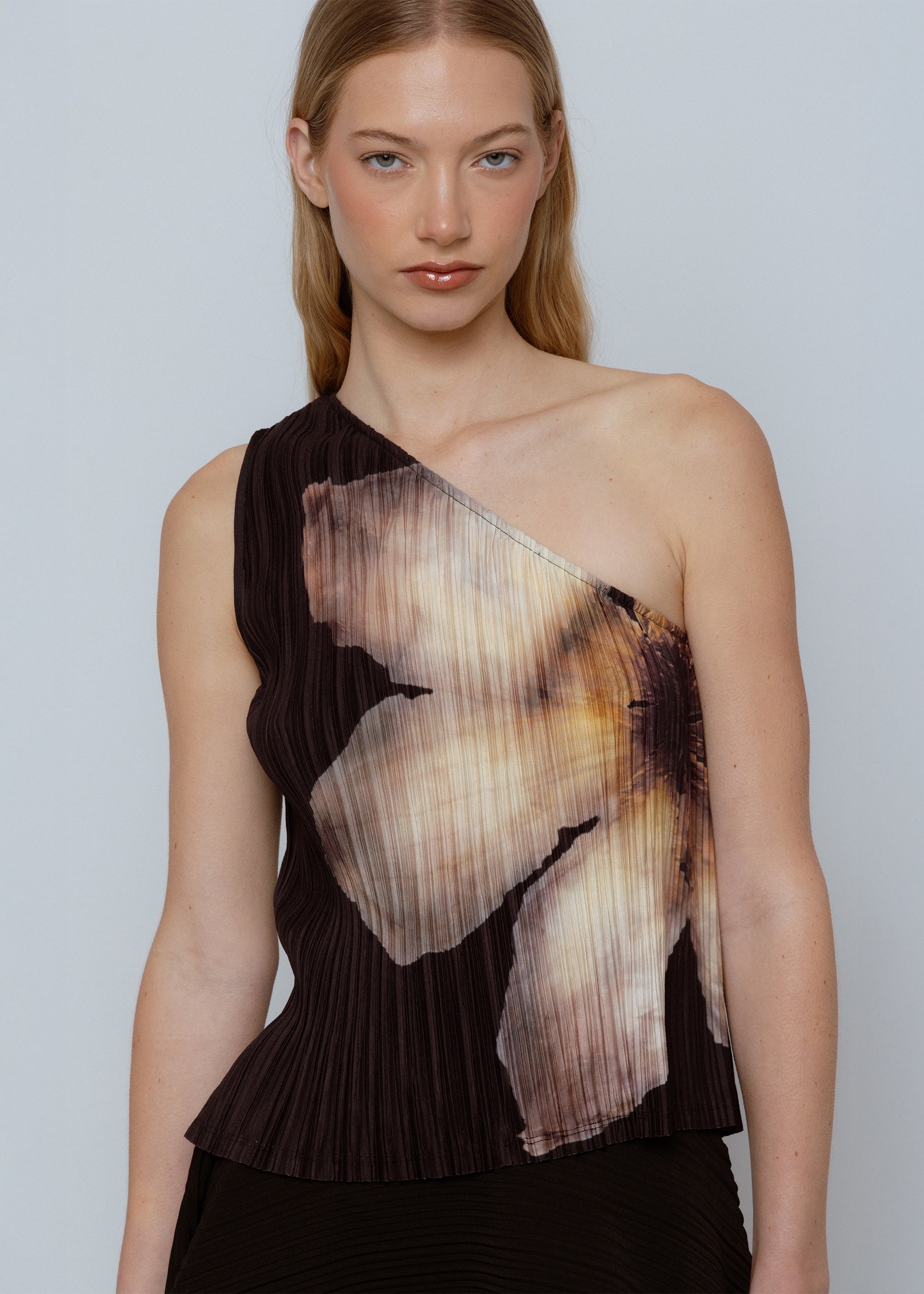 One-shoulder pleated top with abstract ombre print in black, brown, and cream tones