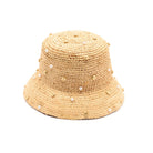 Beige straw bucket hat with pearl embellishments on a white background