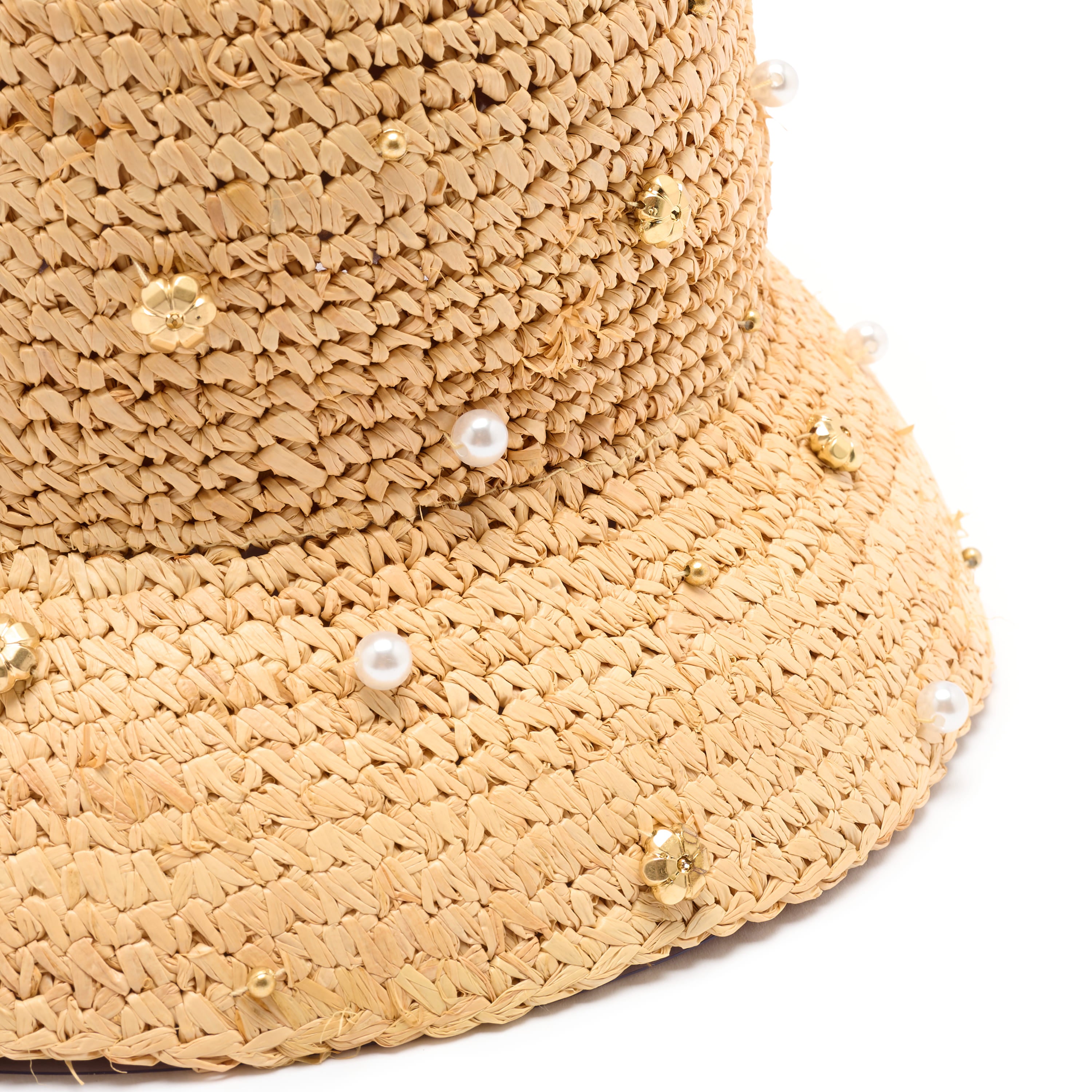 Beige straw hat with pearl and gold bead embellishments on a white background