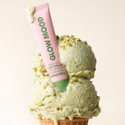 Lip balm with 'doow moh' branding on a scoop of green ice cream.