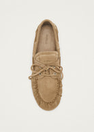 Tan suede moccasin slipper with lace-up detail and ALOHAS branding, viewed from above on beige background