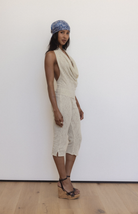 Beige textured halter top with deep V-neck and open back, paired with matching knee-length skirt with front slit