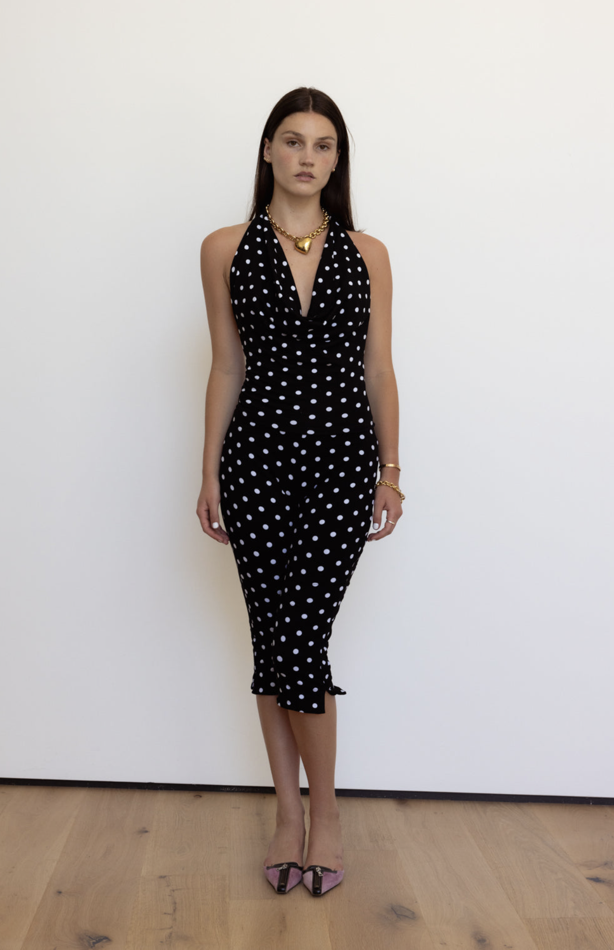 Black polka dot halter neck midi dress with deep V-neckline and ruffle hem detail