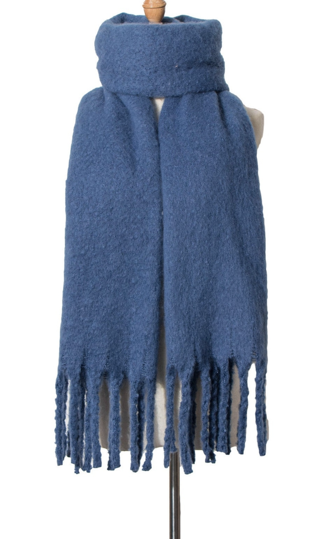 Blue textured knit scarf with fringe tassels displayed on mannequin stand against white background