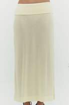 Cream colored maxi skirt with wide fold-over waistband in heathered knit fabric, worn with sandals