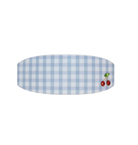 Blue gingham check oval serving platter with small cherry embellishment on white background