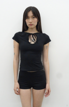 Black short-sleeve top with keyhole cutout and tie detail at neckline, fitted silhouette, worn with black shorts
