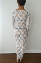 White lace maxi dress with long sleeves and sheer floral pattern, shown from back view on model