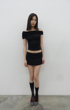 Black off-shoulder crop top and mini skirt set with black socks and checkered heels, full body fashion look