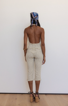 Beige textured knit halter top and matching cropped pants set with open back, worn with cork wedge sandals and patterned headscarf