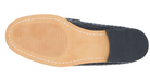 Bottom view of a black woven leather shoe with tan sole and black rubber heel