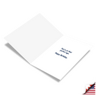 White greeting card with blue text reading "You're at that perfect age. Happy Birthday." displayed at an angle with shadow