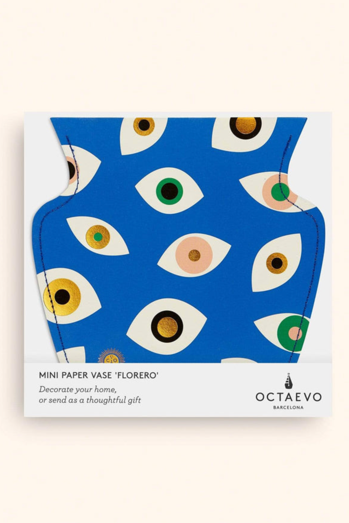 Flat-packed mini paper vase with blue background and colorful eye pattern design by Octaevo Barcelona in white packaging