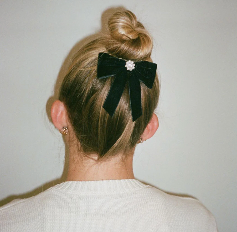 Dark green velvet hair bow with pearl center embellishment on blonde hair bun