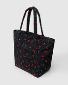 Black quilted tote bag with red rose print pattern and dual shoulder straps
