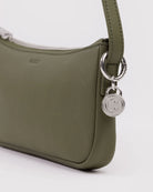 Olive green leather shoulder bag with silver hardware and smiley face charm detail