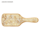 Award-winning paddle hairbrush in cream and tan marbled resin with bamboo trim and EMI JAY branding on handle