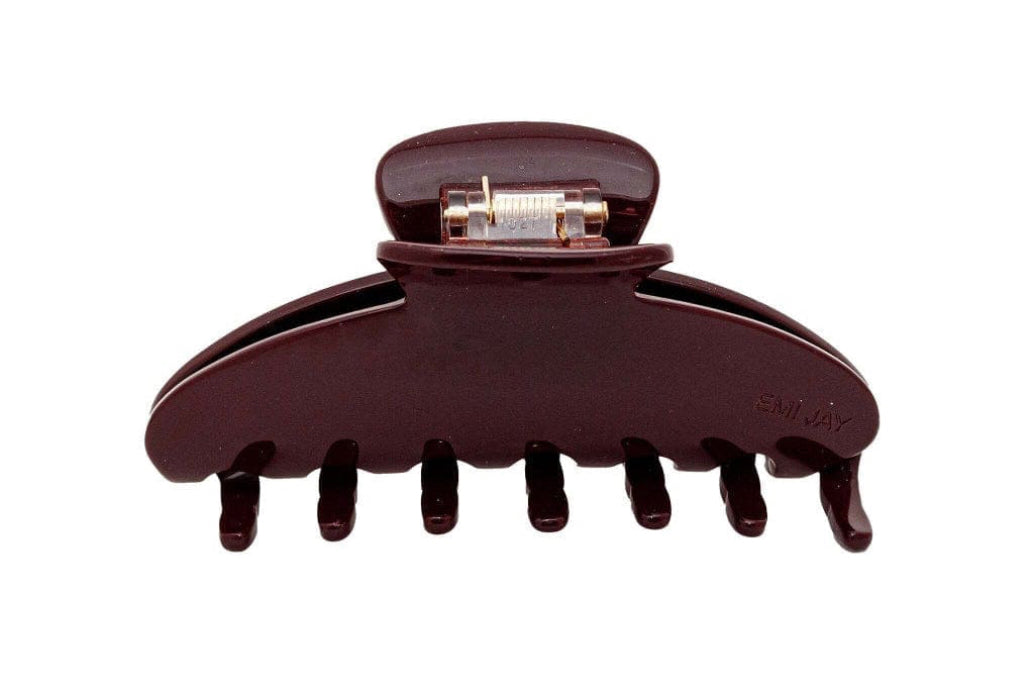 Brown plastic hair claw clip with metal hinge mechanism, featuring curved design with seven teeth for securing hair