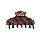 Large tortoiseshell hair claw clip with brown and amber striped pattern and metal clasp closure