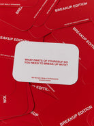 Red card game set titled We're Not Really Strangers Breakup Edition with white card showing introspective question about self-growth