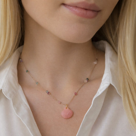 Delicate rose gold necklace with pink rhodochrosite gemstone pendant and small stone accents along chain