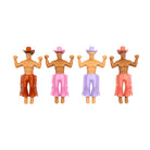 Four plastic cowboy figurines with muscular torsos, colorful cowboy hats and fringed chaps in brown, pink, purple, and coral