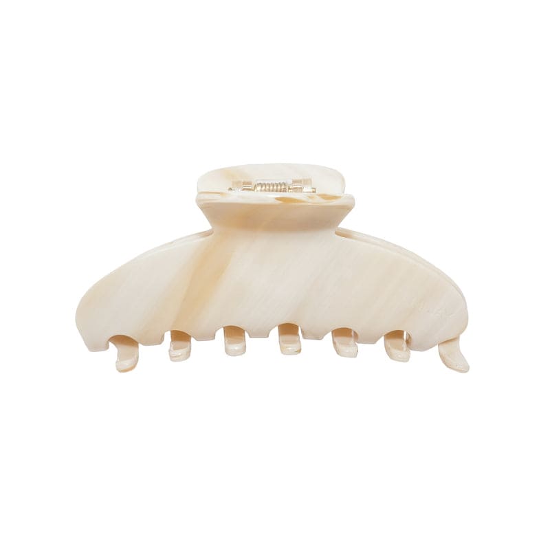 Cream-colored plastic hair claw clip with curved teeth and metal spring clasp mechanism