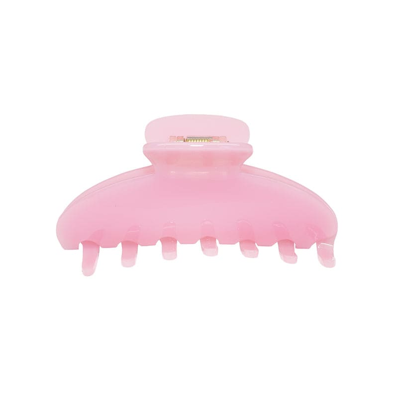 Large pink translucent plastic hair claw clip with teeth and spring clasp mechanism
