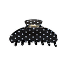 Black polka dot hair claw clip with white dots and metal clasp closure