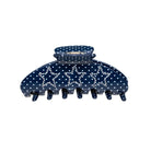 Navy blue polka dot hair claw clip with rhinestone embellishment and multiple teeth clasps