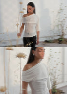 Off-shoulder white ruched stretch top with asymmetric neckline and 3/4 sleeves, draped fabric detail.