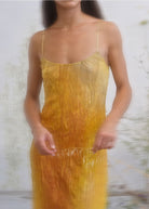Yellow to amber ombre crinkled silk slip dress with spaghetti straps and scoop neckline.