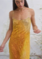 Yellow-orange ombre crinkled slip dress with spaghetti straps, semi-sheer textured fabric, scoop neckline