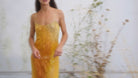 Yellow ombre crinkled silk slip dress with spaghetti straps, gradient from gold to amber, midi length.