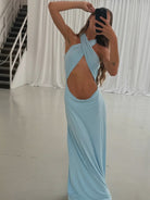 Light blue cross-front cutout maxi dress with halter neckline and floor-length silhouette in soft stretchy fabric