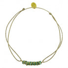 Delicate gold double-strand bracelet with turquoise blue beaded centerpiece and adjustable closure