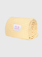 Rolled yellow microfiber towel with Emi Jay label, soft textured fabric for drying hair
