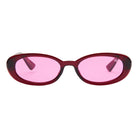 Sunglasses with pink lenses and red frame on a white background