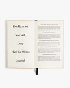 Open cream-colored journal showing title page "Five Reasons You Will Love The Five Minute Journal" and introduction text on facing page