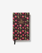 The Five Minute Journal with dark brown cover featuring pink raspberries and green leaves pattern with gold foil text and black ribbon bookmark