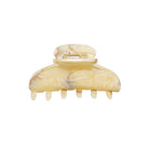 Large yellow marbled resin hair claw clip with gold-tone metal clasp and six curved teeth for securing hair