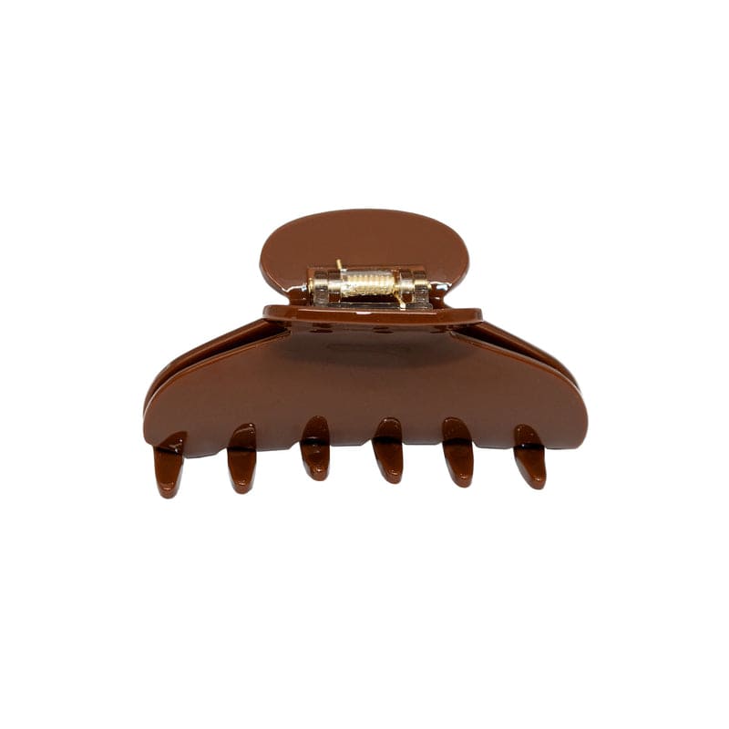 Brown plastic hair claw clip with rounded top and metal clasp closure, featuring six teeth for securing hair
