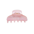 Pink marbled hair claw clip with metal clasp closure and curved teeth design for securing hair