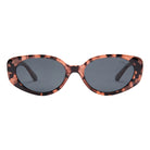 Oval sunglasses with pink and black tortoiseshell frame and dark grey lenses on white background