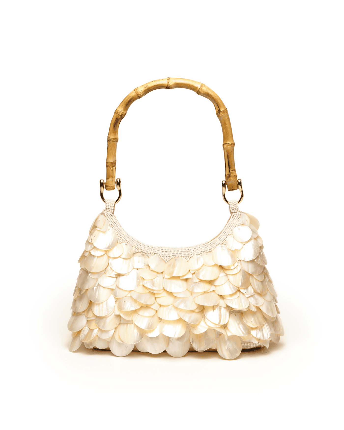Cream-colored handbag with bamboo handle featuring overlapping mother-of-pearl shell embellishments in a scale pattern